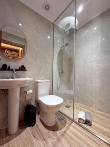 a bathroom with a shower and a toilet and a sink at Gregory Central Apartment in Chania +15 photos