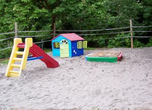 a playground with play equipment in the sand at Pferdehof und Wanderreitstation Dörsam in Mörlenbach
