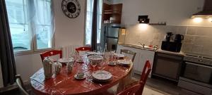 a kitchen with a table with wine glasses on it at Verrecheznous-lepuy in Le Puy-Notre-Dame