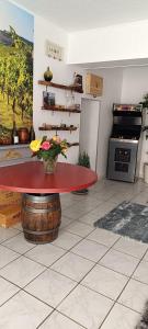 a kitchen with a table with a red counter top at Verrecheznous-lepuy in Le Puy-Notre-Dame