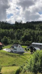 a large white building in the middle of a field at Villa Skoglund in Stranda