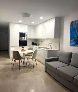 a kitchen and living room with a couch and a table at Marina Luxury in Torrevieja