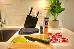 a cutting board with a knife on top of a counter at The Royal Suite in Surrey