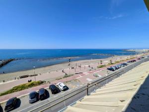 a highway with cars parked next to the beach at ESPRESSO VISTA MARE, Ostia Antica in Lido di Ostia