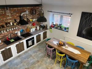 a kitchen with a wooden table and chairs at Dobków 42 in Dobków +63 photos