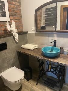 a bathroom with a sink and a toilet at Dobków 42 in Dobków