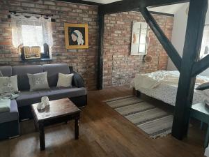 a living room with a couch and a bed at Dobków 42 in Dobków