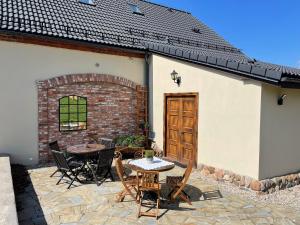 a patio with a table and chairs and a building at Dobków 42 in Dobków