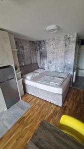 a bedroom with a large bed in a room at XYZ-Osijek in Osijek