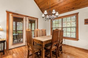 a dining room with a wooden table and chairs at SBL14 -Mayberry Lodge in Branson West