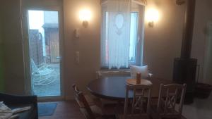 a dining room with a table and chairs and a window at Ferienwohnung an der Ostsee in Dassow