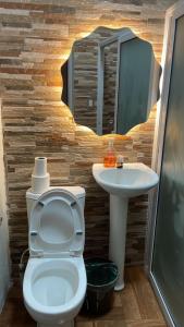 a bathroom with a toilet and a sink at Casa Lolita in San Juan La Laguna +20 photos