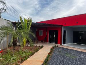a red and white house with a red roof at PousadaOasis in Várzea Grande