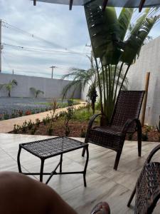 a bench and a coffee table on a patio at PousadaOasis in Várzea Grande