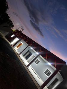 a house with lights on the side of it at PousadaOasis in Várzea Grande +3 photos