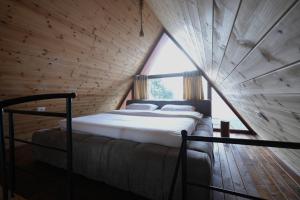 a bedroom with a bed in a wooden room at Dajti Alpin Villas in Tirana +62 photos