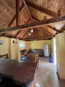 a living room with a wooden ceiling and a table at Rest house Keda in K'eda +5 photos
