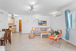 a living room with a couch and a table at Antigone's Blue Vista in Kampos Paros +21 photos
