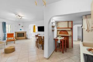 a kitchen and living room with a table and chairs at Antigone's Blue Vista in Kampos Paros