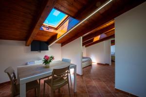 a kitchen and dining room with a table and chairs at Carlo's Luxury Villa in Agerola
