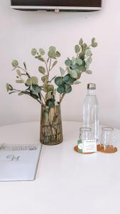 a vase with a plant and a bottle of water at Caniçada Home in Vieira do Minho
