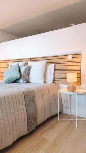 a bedroom with a large bed with a side table at Caniçada Home in Vieira do Minho +61 photos