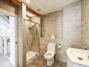 a bathroom with a toilet and a shower and a sink at 4 Bed in Lymington oc-c41423 in Lymington +17 photos