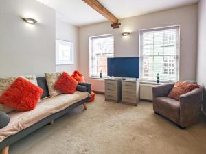 a living room with a couch and a television at 4 Bed in Lymington oc-c41423 in Lymington