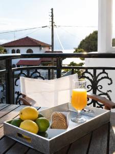 a tray of fruit and a glass of orange juice at Studios Chrissi-Renovated 2026, Just 20m from the Beach in Skala Sotiros