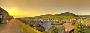an aerial view of a village with houses and mountains at Welsh Bayview Retreat 2-Bed Lodge at Clarach Bay Holiday Village in Aberystwyth