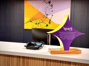 a desk with a purple and yellow star on it at Spark by Hilton Waynesboro in Waynesboro