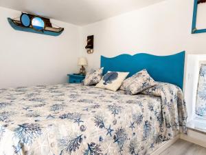 a bedroom with a bed with a blue headboard at La Bella Annacapri in Anacapri +30 photos