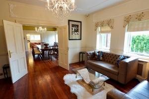 a living room with a couch and a dining room at Ballagh House in Navan