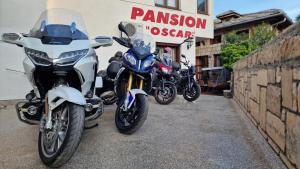 three motorcycles parked in front of a pharmacy at Pansion Oscar Summer Garden in Mostar