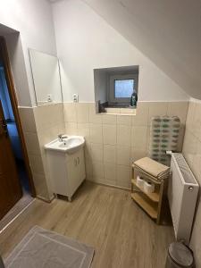 a small bathroom with a sink and a mirror at Gasthaus Radków in Radków +29 photos