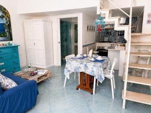 a living room with a table and a blue couch at La Bella Annacapri in Anacapri