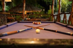 a pool table with three cue balls on it at EcoHotel Inka Minka in Santa Marta