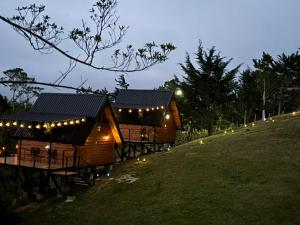 a row of lodges on a hill at night at Brisas De Los Santos Lodge 1 in Sierra +20 photos