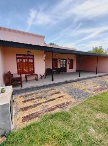 a house with a patio and a yard at Casona Villa Helena in Miramar