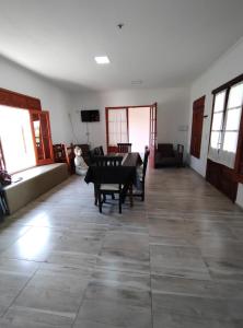 a large living room with a table and chairs at Casona Villa Helena in Miramar