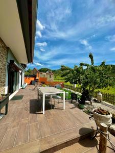 a patio with a white table and chairs on a deck at Quinta Santo Antonio in Gouveia
