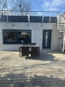 a table and two chairs in front of a building at LaTerrazzaA1 in Hamm
