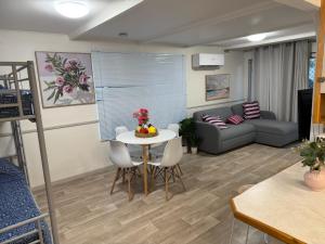 a living room with a table and a couch at Coachstop Caravan Park in Maitland