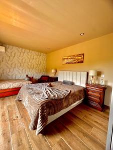 a bedroom with a bed and a wooden floor at Quinta Santo Antonio in Gouveia