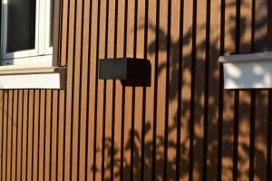 a shadow of a tree on the side of a building at OE concept in Guernica y Luno