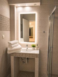 a bathroom with a sink and a mirror at Studios Chrissi-Renovated 2026, Just 20m from the Beach in Skala Sotiros