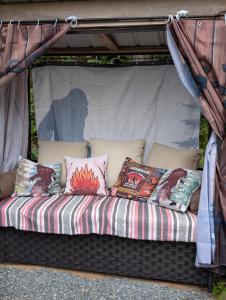 a couch sitting inside of a tent with pillows at Magnolia Cottage Bigfoot Hideaway in Hope