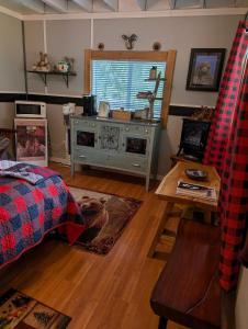 a living room with a bed and a table at Magnolia Cottage Bigfoot Hideaway in Hope
