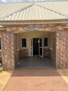 a building with a sign that reads reception at Hanover Hotels Suleja in Tunga Bai