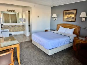 a hotel room with a bed and a bathroom at Bristlecone Motel in Ely